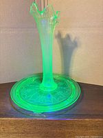 Full view of uranium glass epergne assembled under UV light