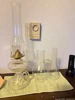 overall view of kerosene lamp with two spare chimneys