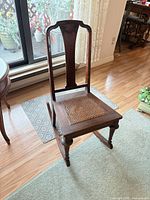 Full view of rocking side chair showing overall form, backrest and rocker rails