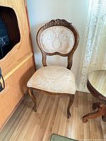 Full view of chair showing frame, upholstery and legs