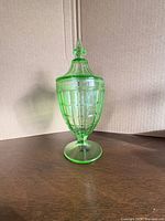 Full view of uranium glass compote with lid on pedestal