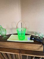 Front view of uranium glass basket on cabinet with UV flashlight showing glow
