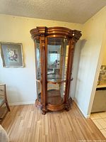 Full view of freestanding curved-glass china cabinet