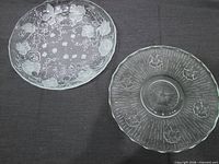 Overview of both clear glass serving plates showing shapes and floral designs