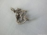 front view of sterling silver dragon pendant showing detailing and bail