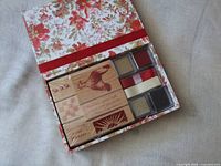 Open Anna Griffin floral box showing four wood stamps and six ink pads