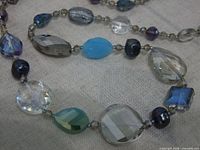 Close-up of assorted faceted glass beads on necklace