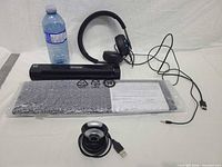 Group shot of Epson scanner, headset, sealed keyboard, webcam with scale reference