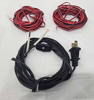 Black power cord with switch and plug, two coils of red-black wire