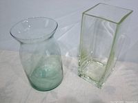 Round flared-rim vase and tall rectangular vase side by side
