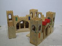 Overall view of wooden castle sections with towers, walls, arches and staircases