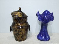 Metal vessel and blue ceramic vase side by side
