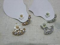 Front view of both gold-tone and silver-tone ear jacket pairs on cards