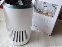 Morento air purifier placed beside its retail box