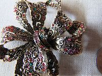 front view showing multicolour rhinestone bow brooch detail
