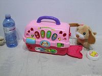 Front view of carrier with water bottle for scale, plush puppy, bowl with bone