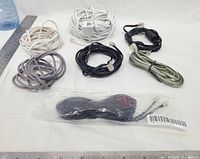 Assorted telephone cords with RJ11 connectors including sealed one