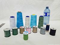 Front view showing all five large cones and eight upright small spools plus one lying spool