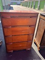 Front view of four-drawer walnut waterfall dresser