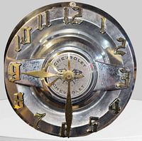 Front view of Chevrolet hubcap clock showing emblem, numerals, and hands