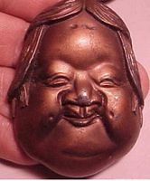 Front view of copper-wash Asian head paperweight