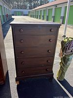 Front view of five-drawer chest showing all drawers and knobs
