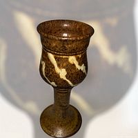 Profile view of stoneware chalice showing glaze and slip-trail decoration