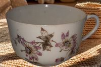 Side view showing Autumn Leaf floral design and gold rim on teacup