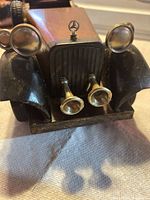 Front view showing grille, twin horns, headlights and hood ornament