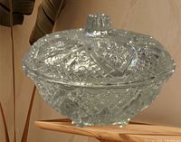 Top angled view of entire lidded candy dish showing diamond pattern and motifs