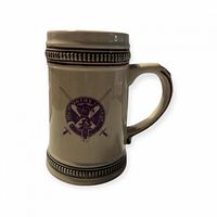 Front view of cream ceramic stein showing purple McMurtry College crest