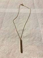 Full view of necklace with bar pendant and chain