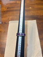 Purple-tone band on ring sizer, shows size near 10