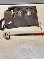 Canvas Honda roll with wrenches and separate adjustable pipe wrench displayed