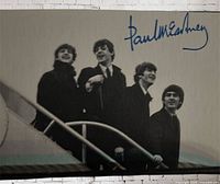 Front of card showing The Beatles boarding plane with blue Paul McCartney facsimile signature