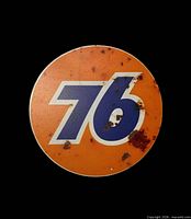 Front view of entire round 76 sign showing logo and faux rust