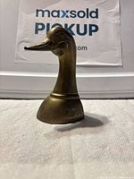 Front view of brass duck head bookend