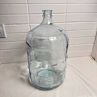 Full view of clear glass jug standing upright