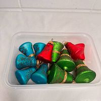 All ten glass bell ornaments inside clear tub