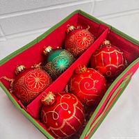 Open storage tray showing six ornaments and dividers