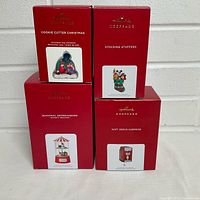Front view of four Hallmark Keepsake ornament boxes showing titles and images