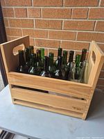 overall view of wooden crate filled with empty wine bottles