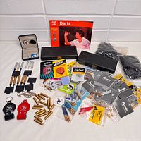 Overview of entire assortment laid out including packaged flights, stems, weights, sharpeners and hardware