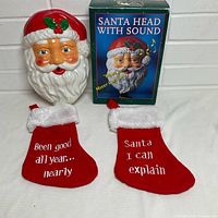 Front view of Santa head, original box, two stockings displayed