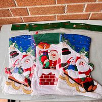 Three sealed stockings side by side, showing two blue-cuff designs and one green-cuff design with Avon header cards