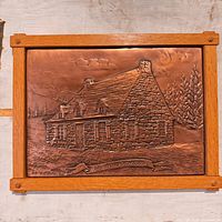 Front view of La Canadienne embossed copper panel in wood frame