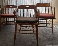 Front view of three wooden pub chairs showing overall design and cushions
