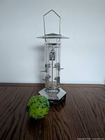 Full view of bird feeder and bee ball