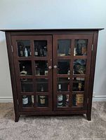 Front view of walnut stained credenza with two glass doors