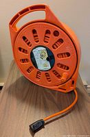 Orange retractable extension cord on reel